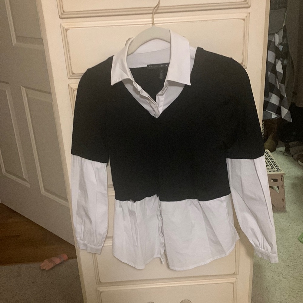 One piece. Black and white , blouse. Looks like two pieces.